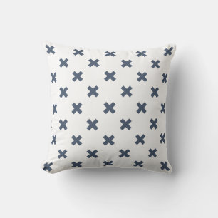 Blue-grey cross stitches on white cushion