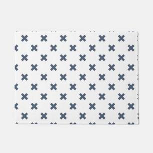 Blue-grey cross stitches on white doormat