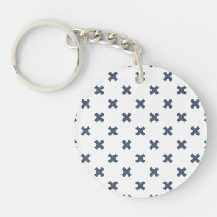 Blue-grey cross stitches on white key ring