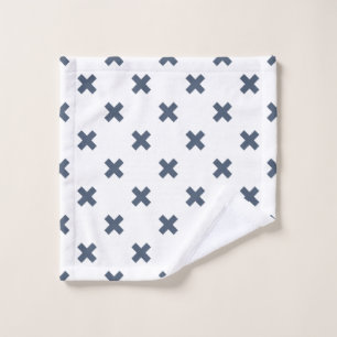 Blue-grey cross stitches on white wash cloth