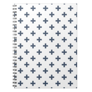 Blue-grey polka crosses on white notebook