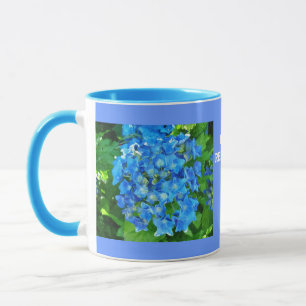 blue hydrangea flowers and its green leaves mug
