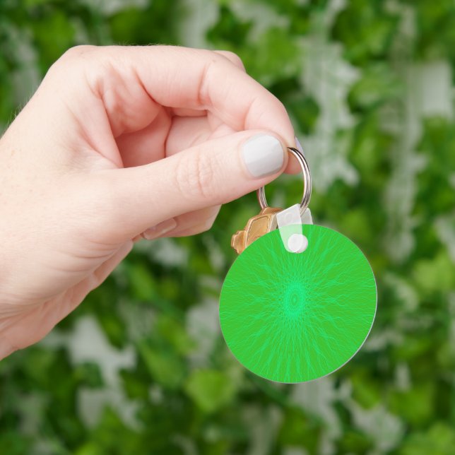 Blue mandala rays on green key ring (Hand)