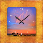 Blue pink and orange sky rainbow sunrise photo square wall clock<br><div class="desc">Appreciate the beauty of nature whenever you check the time on this photography wall clock of a rainbow nestled in a blue, pink, and orange softly lit sunrise. Your choice of a round or square clock face. Makes a great housewarming gift! You can easily personalise this wall clock plus I...</div>