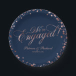 Blue Rose Gold We're Engaged Engagement Party Paper Plate<br><div class="desc">Elegant calligraphy engagement party paper plate. Easy to personalise with your details. Please get in touch with me via chat if you have questions about the artwork or need customisation. PLEASE NOTE: For assistance on orders,  shipping,  product information,  etc.,  contact Zazzle Customer Care directly https://help.zazzle.com/hc/en-us/articles/221463567-How-Do-I-Contact-Zazzle-Customer-Support-.</div>