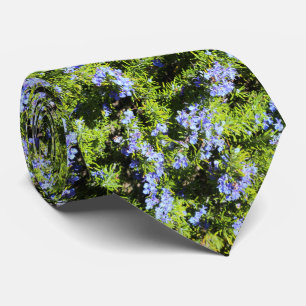 blue rosemary flowers on green needles tie