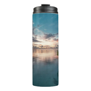 blue sky with red and dark clouds reflected on sea thermal tumbler