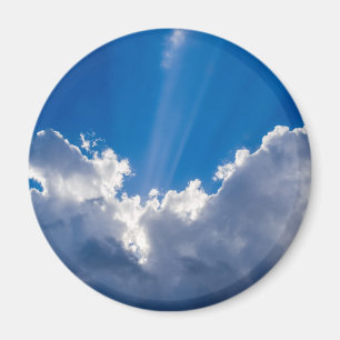 Blue sky with white clouds and ray of sunshine. magnet