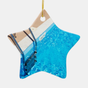 Blue swimming pool with ladder ceramic tree decoration