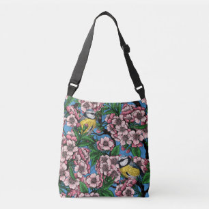 Blue tit birds in the blooming cherry tree on blue crossbody bag