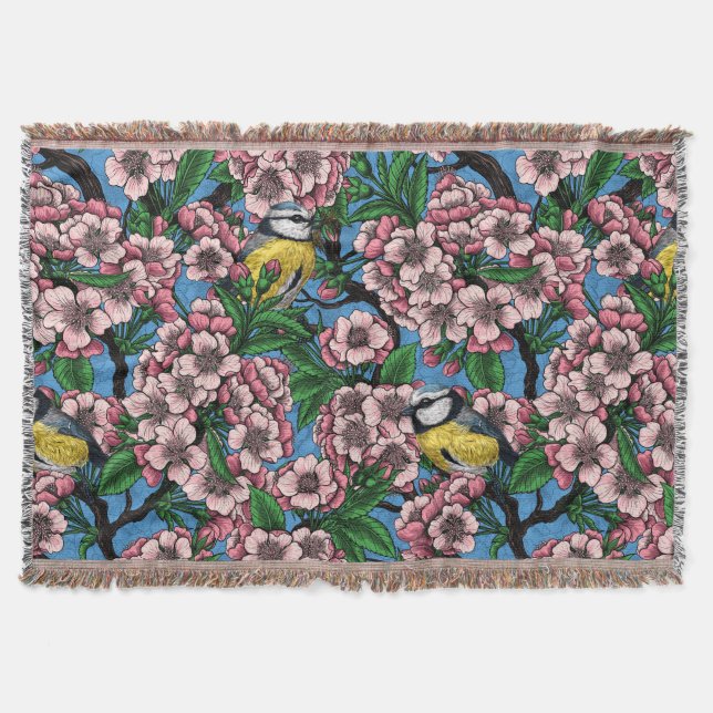Blue tit birds in the blooming cherry tree on blue throw blanket (Front)