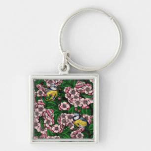 Blue tit birds in the blooming cherry tree on gree key ring