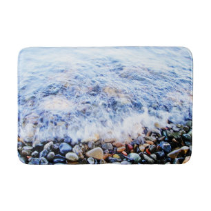 Blue water and colourful stones bath mat
