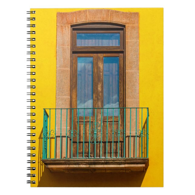 Blue wooden door on yellow concrete building notebook (Front)
