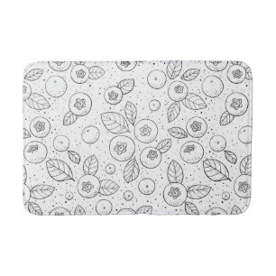 Blueberries on black and white bath mat