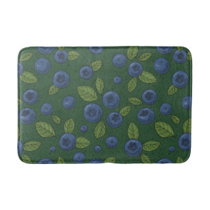 Blueberries on dark green bath mat