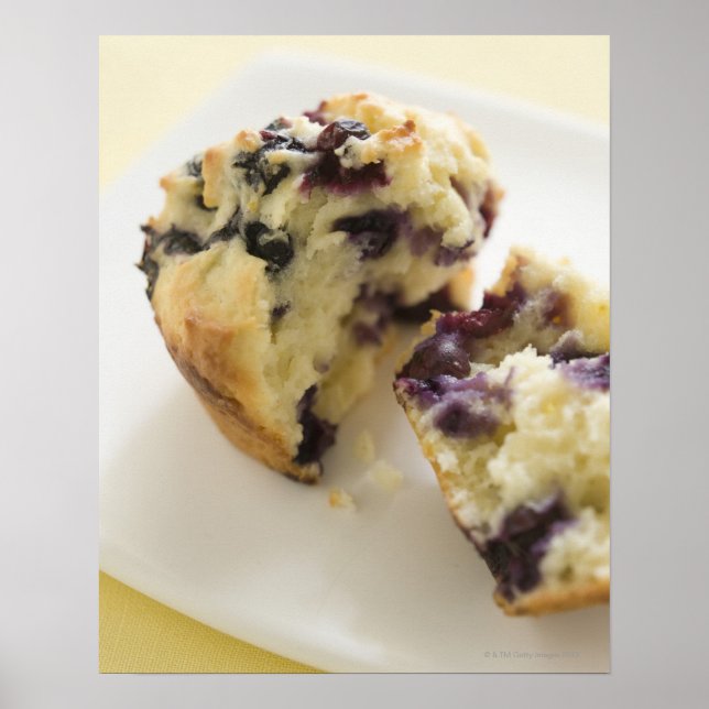 Blueberry muffin split open on a white plate poster (Front)