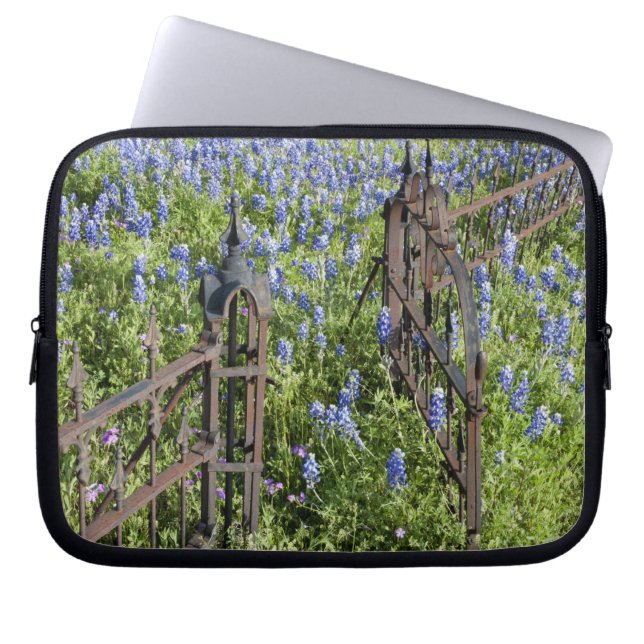 Bluebonnets and phlox surrounding cemetery gate laptop sleeve (Front)