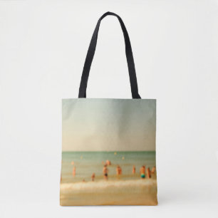 Blurred beach photo with bokeh. People relaxing on Tote Bag