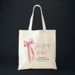 Blush Pink Bow She's Tying the Knot Bridal Shower  Tote Bag<br><div class="desc">The "Blush Pink Bow: She's Tying the Knot" Bridal Shower Tote Bag is a stylish and practical accessory for the bride-to-be and her bridal party. With its elegant blush pink bow design, this tote bag adds a touch of sophistication to any bridal shower celebration. Spacious enough to hold essentials like...</div>