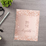 Blush rose gold glitter dust monogram name 2025 planner<br><div class="desc">A rose gold background with elegant blush faux glitter dust. Personalise and add a year (upside down) and add a name. The name is written in dark rose gold with a large modern hand lettered style script with swashes. Perfect for school, work or organising your personal/family life. To keep the...</div>