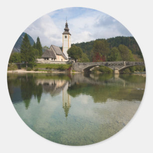Bohinj lake with church in Slovenia round sticker