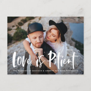 Bold Brush Script Love is Patient Postponement Announcement Postcard