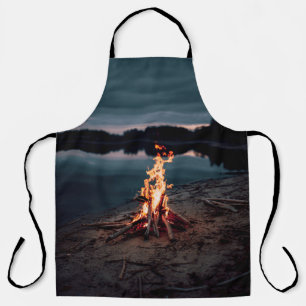 Bonfire near body of water during night time apron