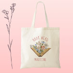 Book Nerd  Tote Bag<br><div class="desc">Know a book lover that is a total book nerd? This is the gift for them (or for you!) Pretty open book with flowers is done in watercolor with lovely blooms growing out of the book. Add name to personalize! See coordinating items in our shop,  Enchanted Finch.</div>