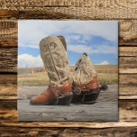 Boots & Spurs Tile<br><div class="desc">A stunning Wyoming sky is the backdrop for this photograph of worn western boots complete with genuine custom made silver spurs, complete with 1880's Mexican pesos for rowels. A perfect gift idea for the cowboy, cowgirl, or anyone who loves the West!</div>