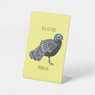 Bornean peacock-pheasant bird cartoon illustration pedestal sign