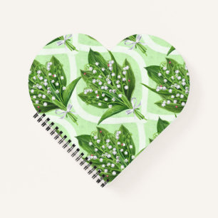 Bouquet of lilly of the valley flowers on green notebook