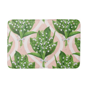 Bouquet of lilly of the valley flowers on pink bath mat