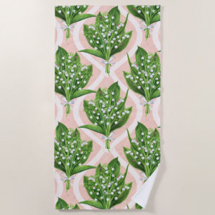 Bouquet of lilly of the valley flowers on pink beach towel