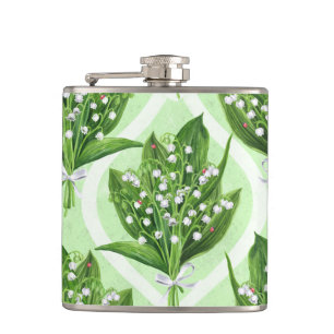 Bouquet of lily of the valley flowers on blue hip flask