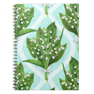 Bouquet of lily of the valley flowers on blue notebook