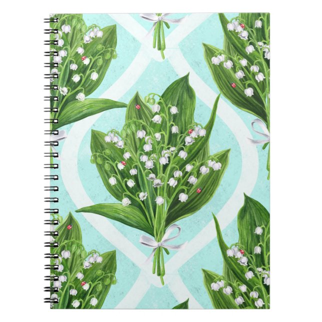 Bouquet of lily of the valley flowers on blue notebook (Front)