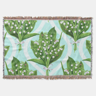 Bouquet of lily of the valley flowers on blue throw blanket