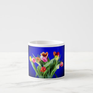 Bouquet of tulips on blue espresso cup