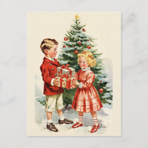 Boy and girl giving each other Christmas presents Postcard
