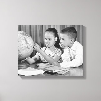 Boy and Girl Viewing Globe Canvas Print