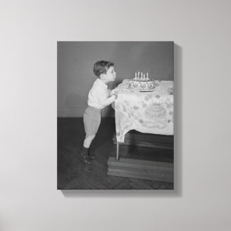 Boy Blowing Out Candles Canvas Print