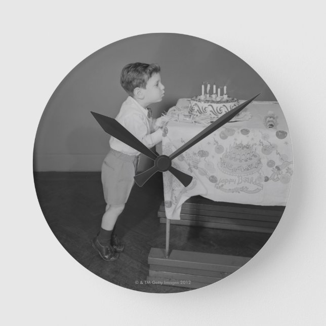 Boy Blowing Out Candles Round Clock (Front)