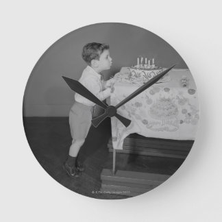 Boy Blowing Out Candles Round Clock