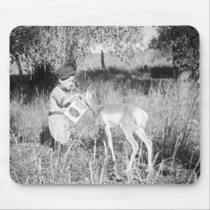 Boy feeding antelope mouse mat