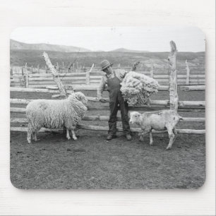Boy holding up a bundle of wool mouse mat