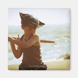 Boy playing pirate, wooden sword magnet