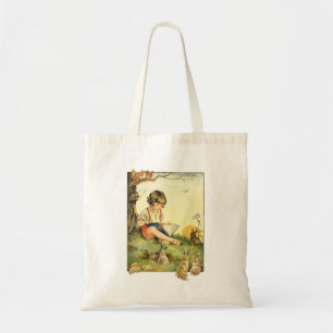 Boy reading under tree with rabbits tote bag