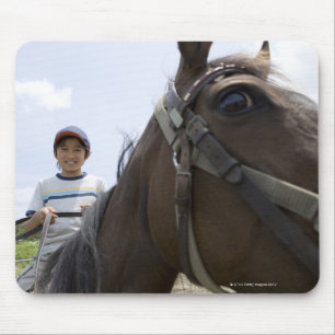 Boy riding a horse mouse mat