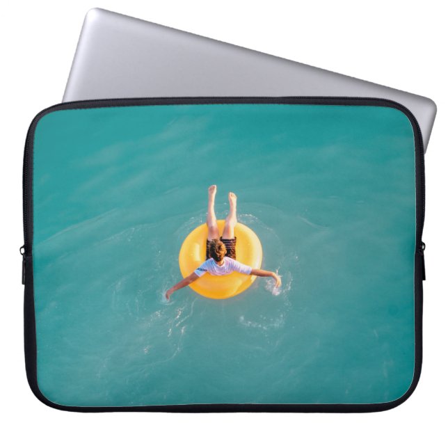 Boy sitting on buoy laptop sleeve (Front)